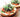 Toasted Go Bagels with assorted savory spreads and schmears, including green herb cream cheese and dark olive tapenade, ready for a delicious meal.