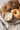 Assorted bagels—plain, sesame, poppy, everything—on a plate.