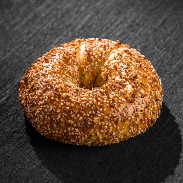 Go Bagels' everything bagel, generously topped with sesame seeds, poppy seeds, and dried garlic.