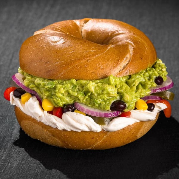 Go Bagels' bagel with guacamole, cream cheese, red onion, corn, black beans, and red peppers.