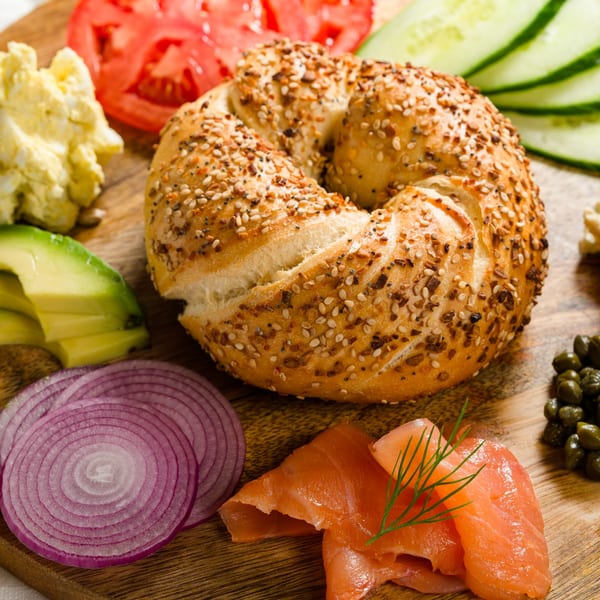 Everything bagel with smoked salmon, capers, red onion, avocado, egg salad, tomato, and cucumber.