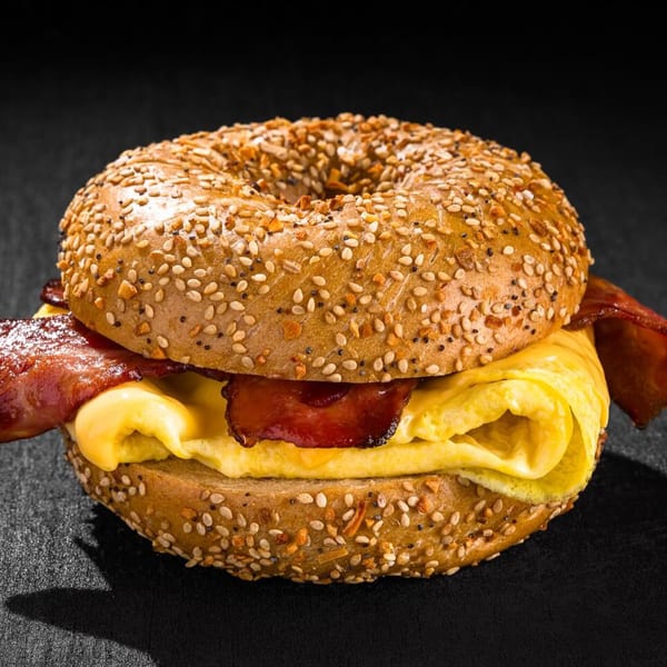 Go Bagels everything bagel with crispy bacon, fluffy scrambled eggs, and melted cheese.